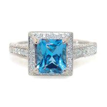 Load image into Gallery viewer, Emerald Cut Blue Topaz Ring in 14k White Gold Diamond Halo
