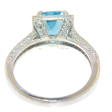 Load image into Gallery viewer, Emerald Cut Blue Topaz Ring in 14k White Gold Diamond Halo
