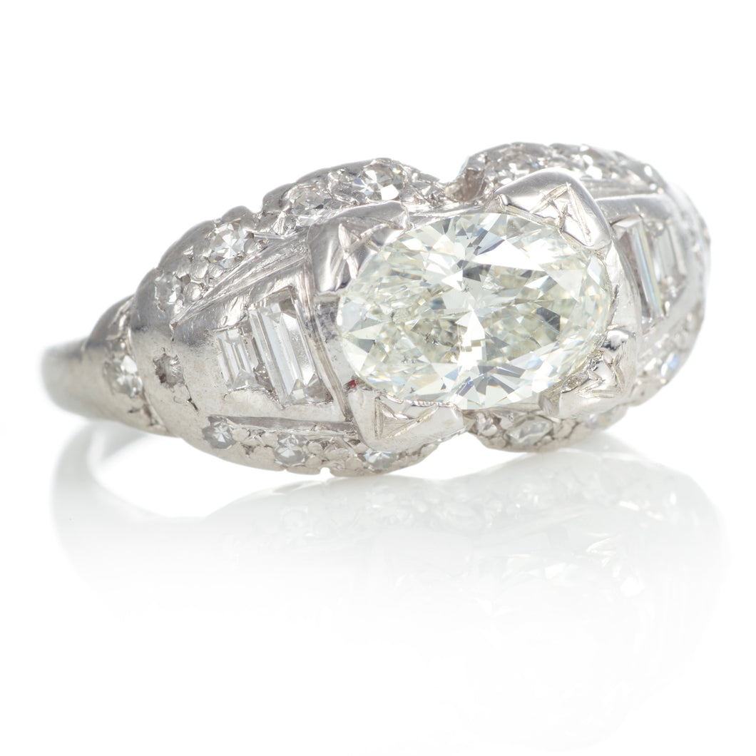 Vintage Platinum Oval Diamond Ring with Accent Diamonds and Filigree