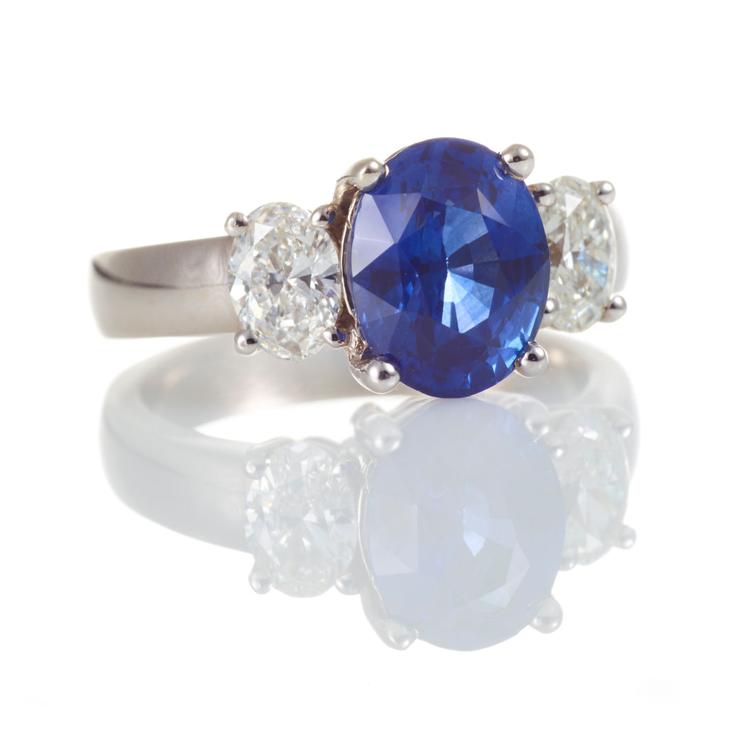Round Blue Sapphire and Oval Diamond Three Stone Ring in 14k White Gold